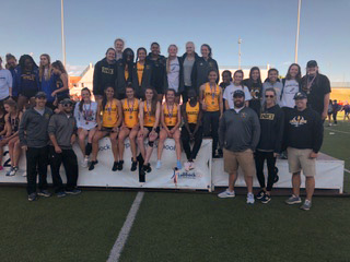 Girls track team and coaches pose after their Area win. 