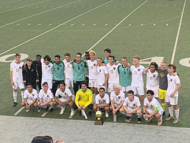 The Sandie soccer team poses with their Bi-District trophy. 