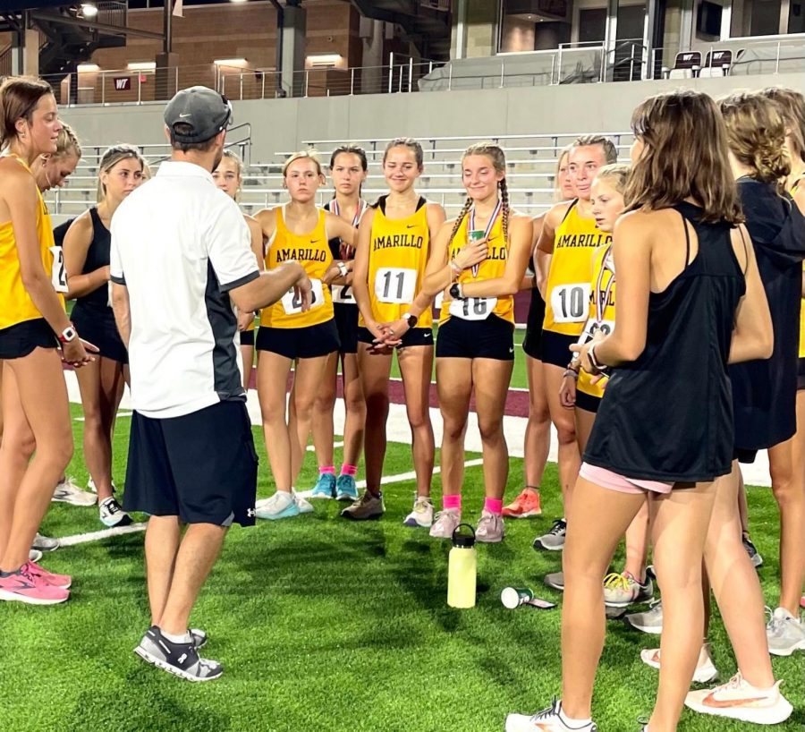 Coaches talk to the girls team before a meet