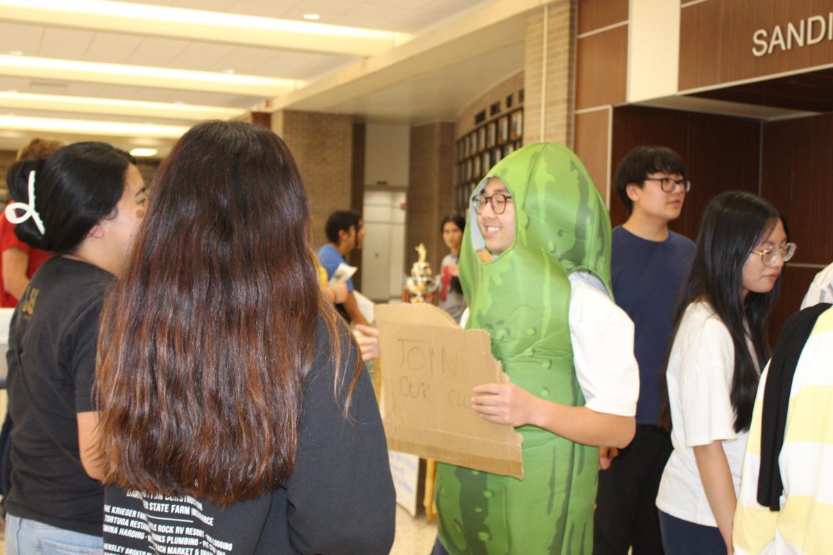 Quan Nguyen dressed as a pickle to help grab attention so students would sign up for Helping Hands.