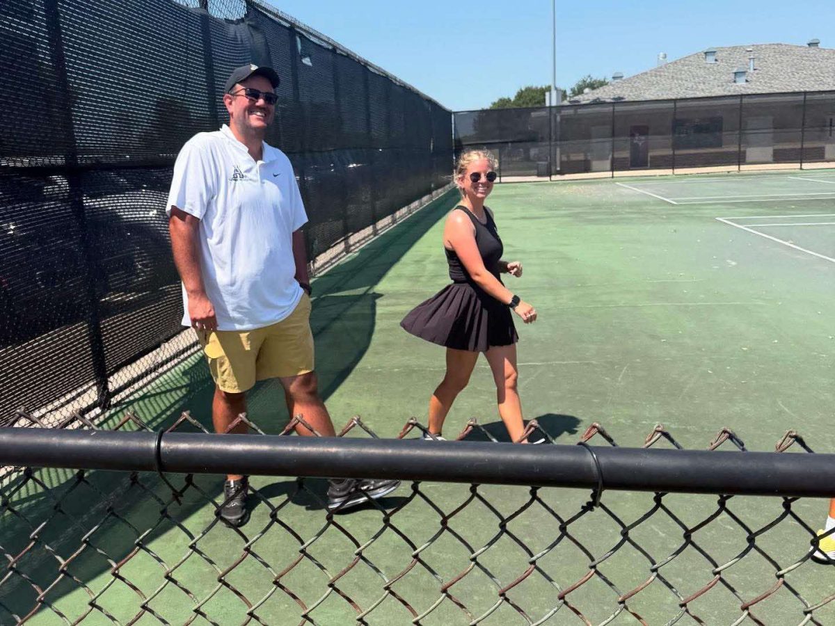 Couch Crouch and Couch Ruppanner walk the courts at the Tennis Center